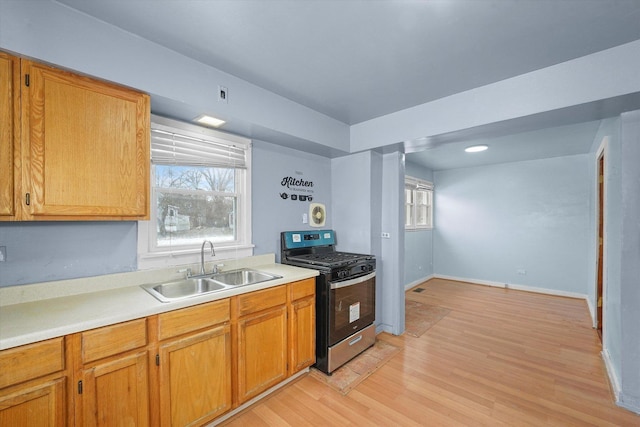 kitchen featuring light hardwood / wood-style flooring, sink, and stainless steel range with gas cooktop