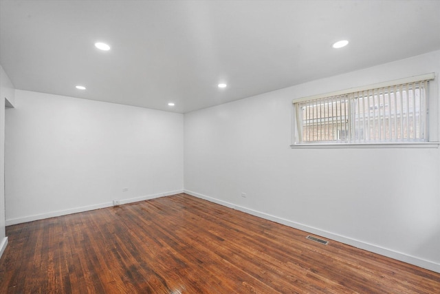 empty room with dark wood-type flooring