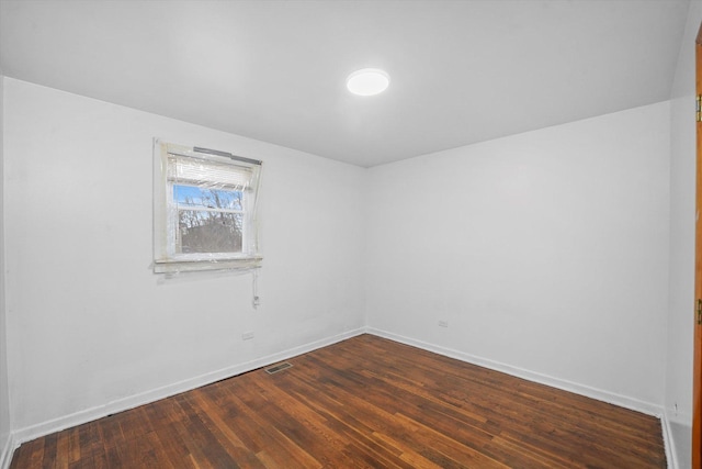 spare room featuring dark hardwood / wood-style floors