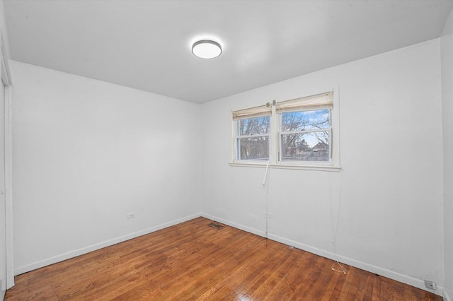 spare room featuring hardwood / wood-style flooring