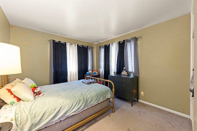 bedroom featuring light colored carpet