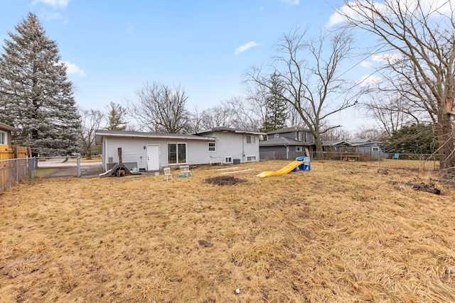 rear view of property featuring a yard