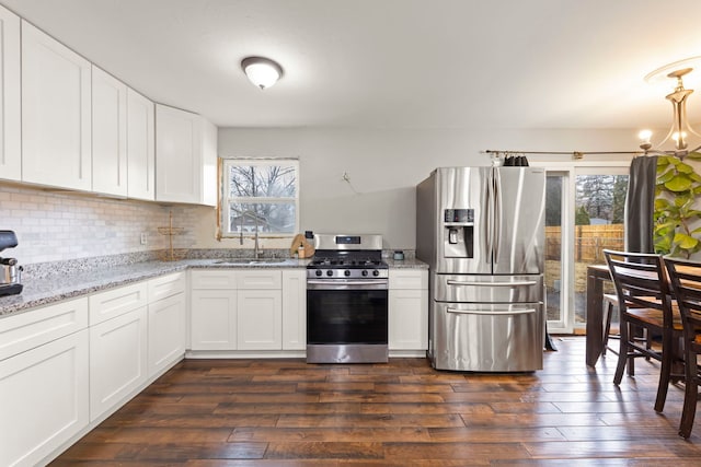 kitchen with stainless steel appliances, sink, white cabinets, and dark hardwood / wood-style floors