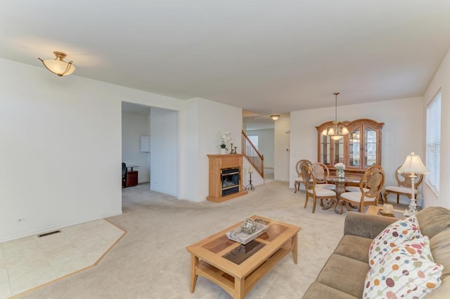 living room with light colored carpet and a chandelier