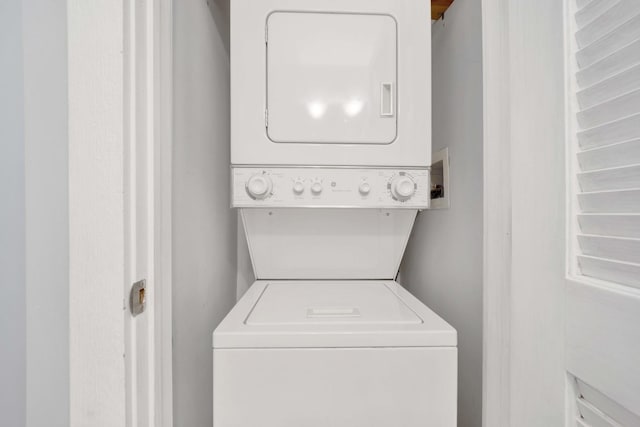 laundry room with stacked washer / dryer