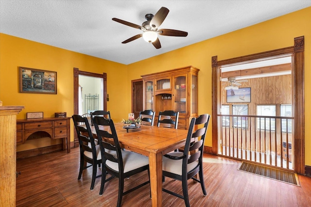 dining space with dark hardwood / wood-style floors and ceiling fan