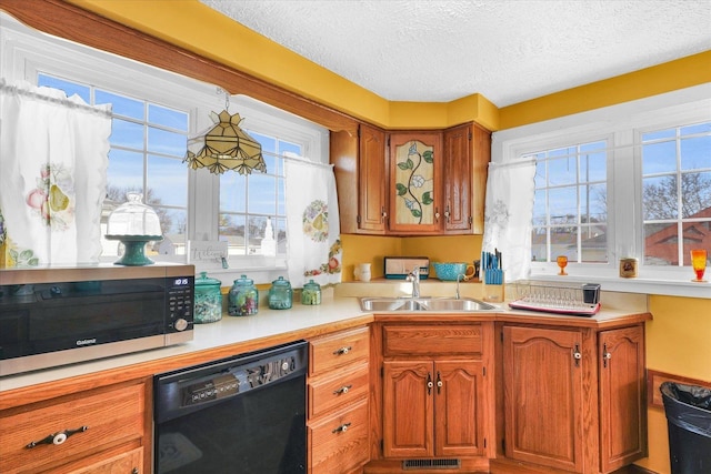 kitchen featuring sink, a textured ceiling, and black dishwasher