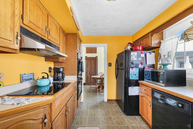 kitchen featuring a textured ceiling and black appliances