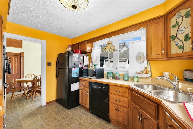 kitchen featuring sink, a textured ceiling, and black appliances