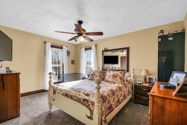 carpeted bedroom with ceiling fan and a textured ceiling