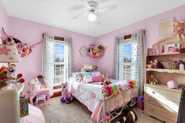 bedroom featuring ceiling fan, carpet, and a textured ceiling