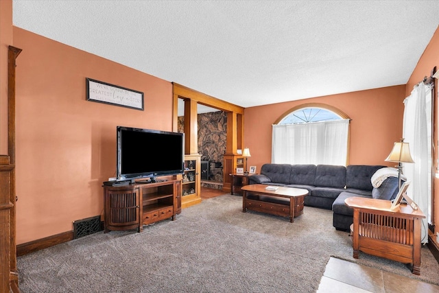 living room featuring a textured ceiling and carpet