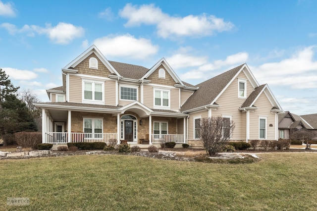 craftsman-style home with covered porch and a front yard