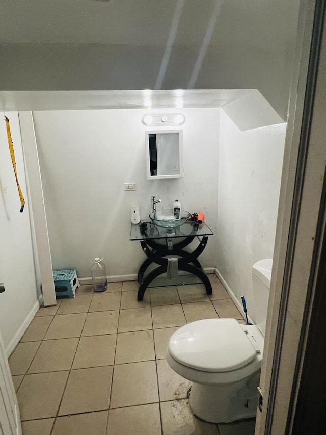 bathroom featuring toilet and tile patterned flooring