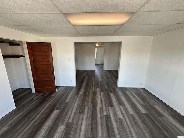 unfurnished room with dark hardwood / wood-style floors, a paneled ceiling, and ceiling fan