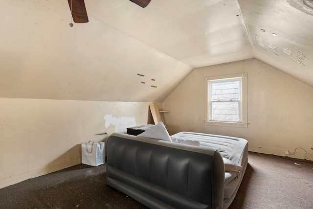 bedroom featuring dark colored carpet, vaulted ceiling, and ceiling fan