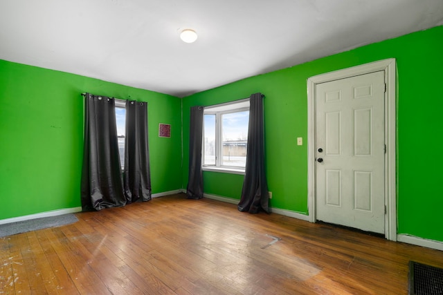 unfurnished room featuring hardwood / wood-style flooring