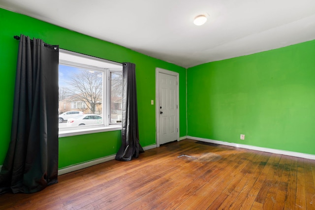 spare room featuring wood-type flooring