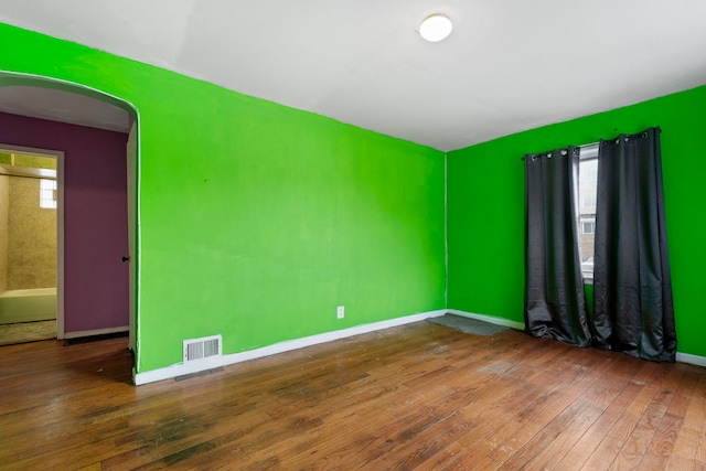 empty room with dark hardwood / wood-style flooring