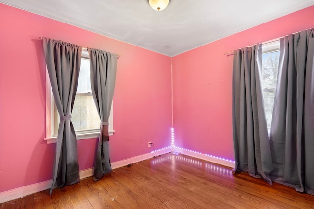 empty room featuring hardwood / wood-style floors and a wealth of natural light