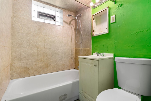 full bathroom with vanity, tiled shower / bath, and toilet