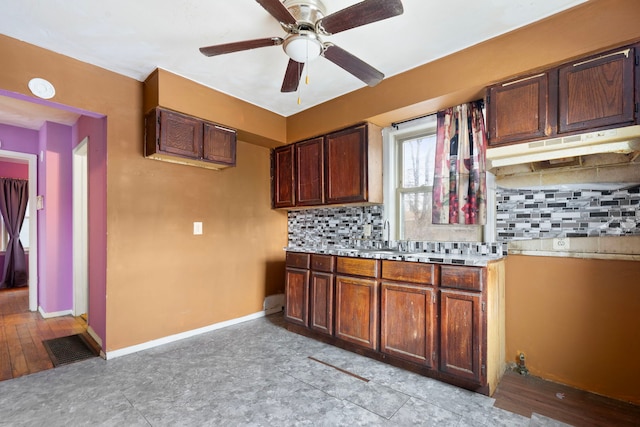 kitchen with tasteful backsplash, ceiling fan, and sink