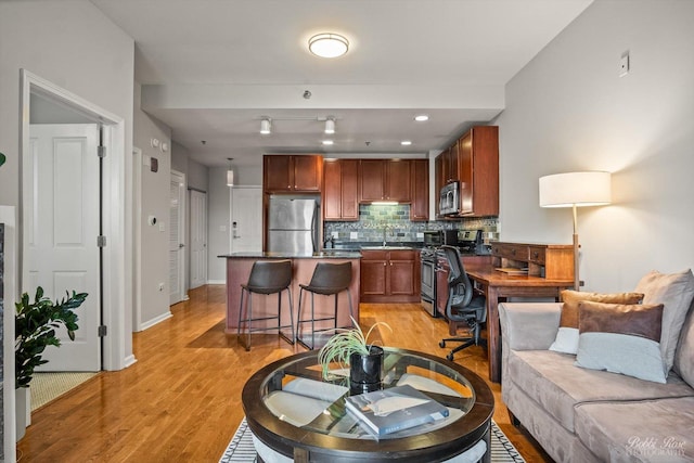 living room featuring sink and light wood-type flooring