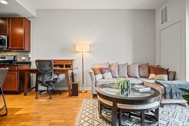 living room with light hardwood / wood-style flooring