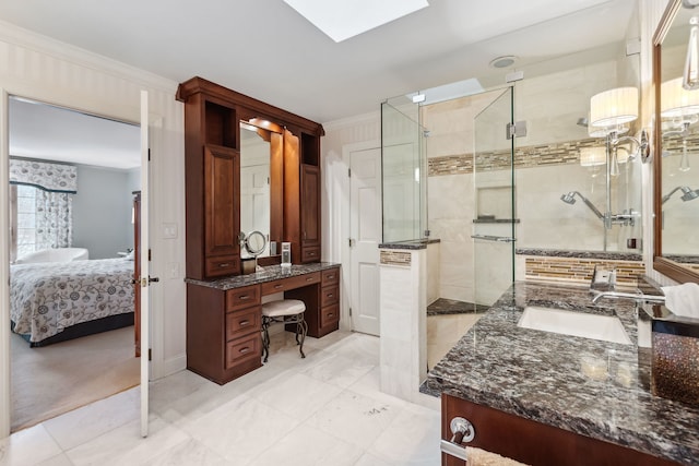 bathroom featuring a skylight, crown molding, vanity, and walk in shower