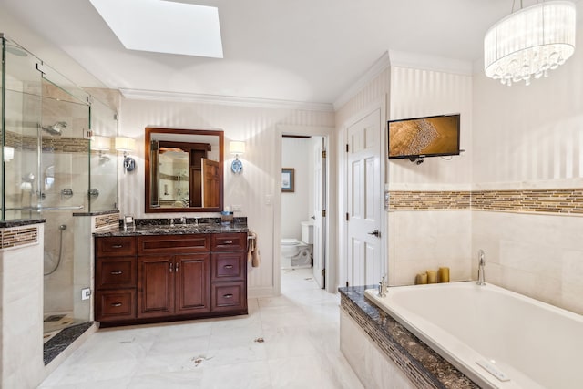 full bathroom with toilet, crown molding, separate shower and tub, a skylight, and vanity