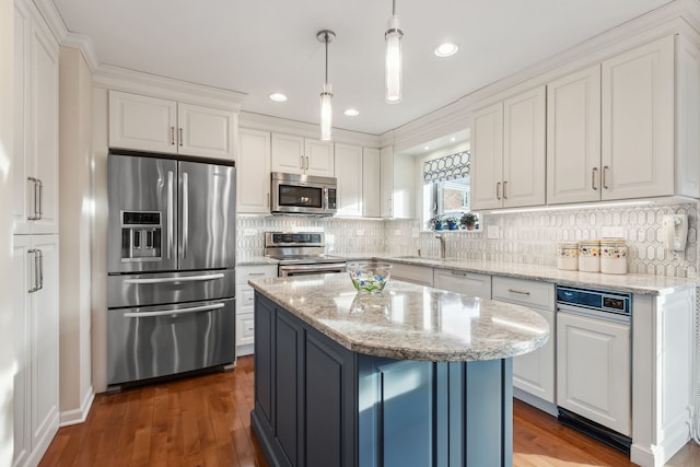 kitchen with pendant lighting, stainless steel appliances, a center island, light stone counters, and white cabinets