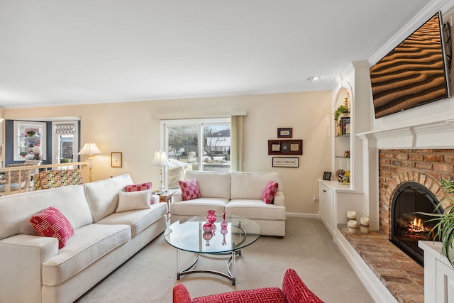 living room with a brick fireplace, ornamental molding, and light colored carpet