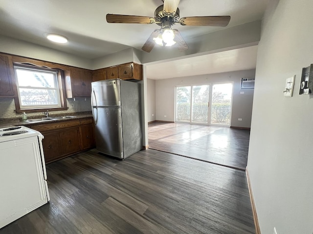 kitchen featuring backsplash, sink, stainless steel fridge, and dark hardwood / wood-style floors