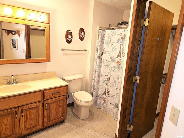 bathroom with a shower with curtain, tile patterned floors, vanity, and toilet