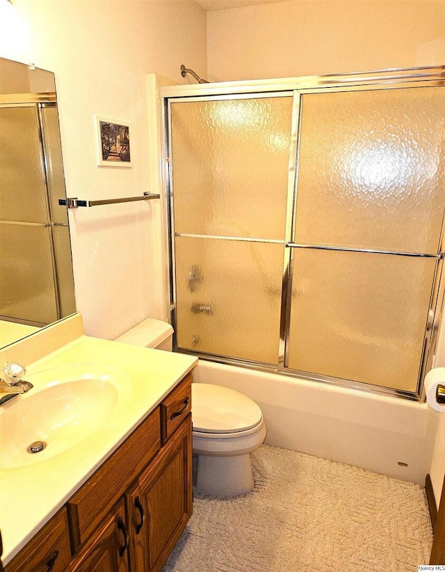 full bathroom featuring vanity, toilet, and combined bath / shower with glass door