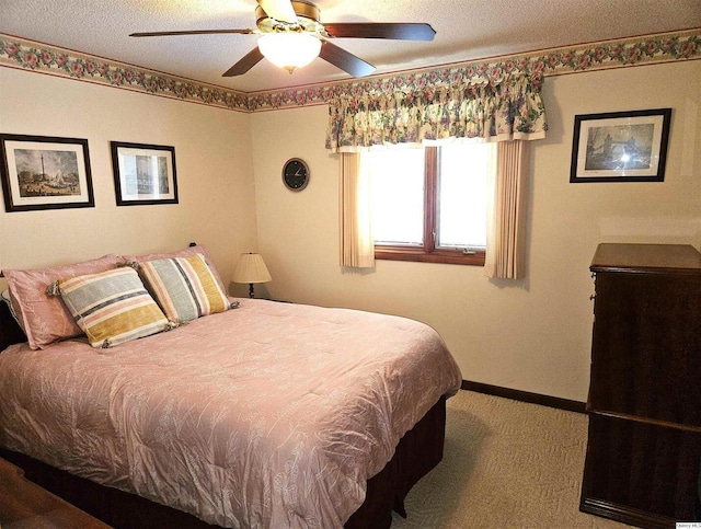 bedroom featuring ceiling fan, carpet flooring, and a textured ceiling