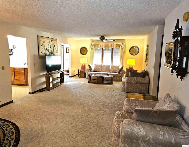 carpeted living room with ceiling fan and a textured ceiling