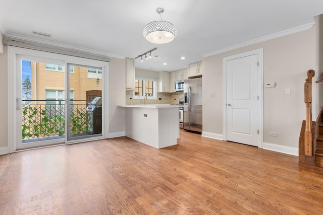 kitchen featuring white cabinets, backsplash, kitchen peninsula, stainless steel appliances, and crown molding