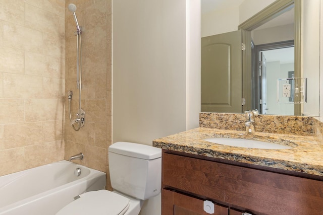 full bathroom with vanity, tiled shower / bath, and toilet