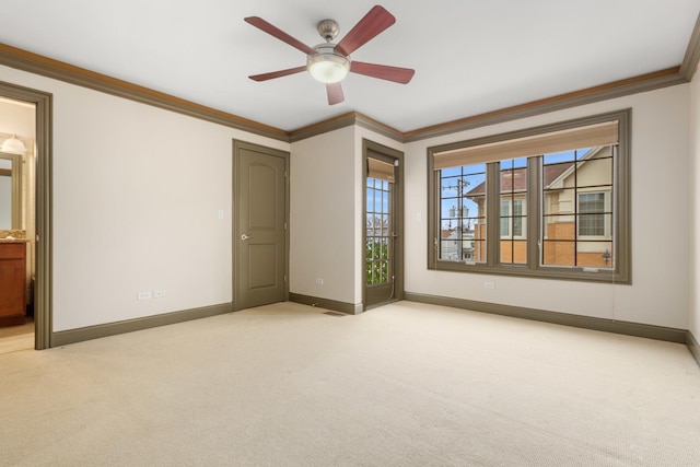 unfurnished bedroom featuring light carpet, ornamental molding, ceiling fan, and ensuite bathroom