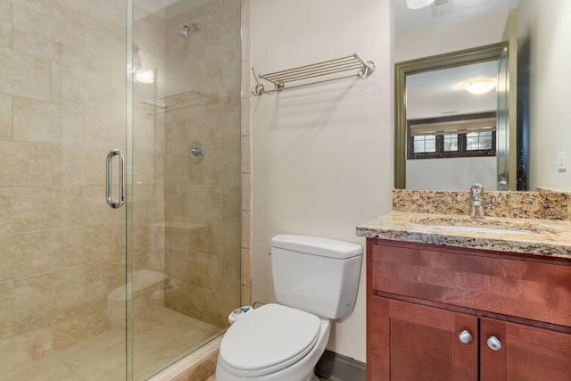 bathroom featuring vanity, toilet, and walk in shower