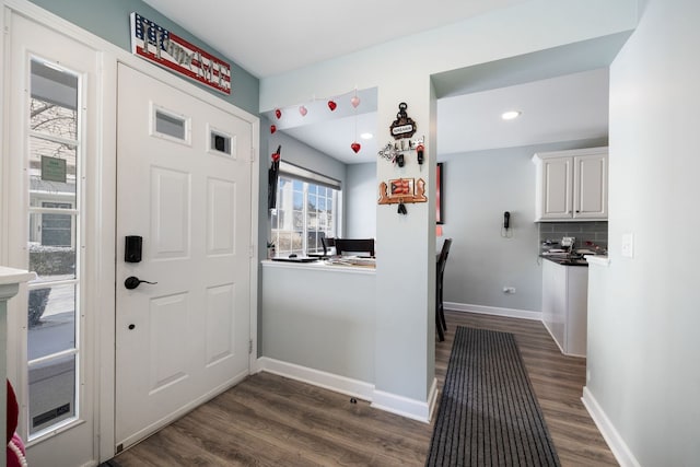 entryway with dark hardwood / wood-style flooring