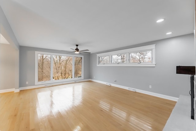 unfurnished living room with ceiling fan and light hardwood / wood-style floors