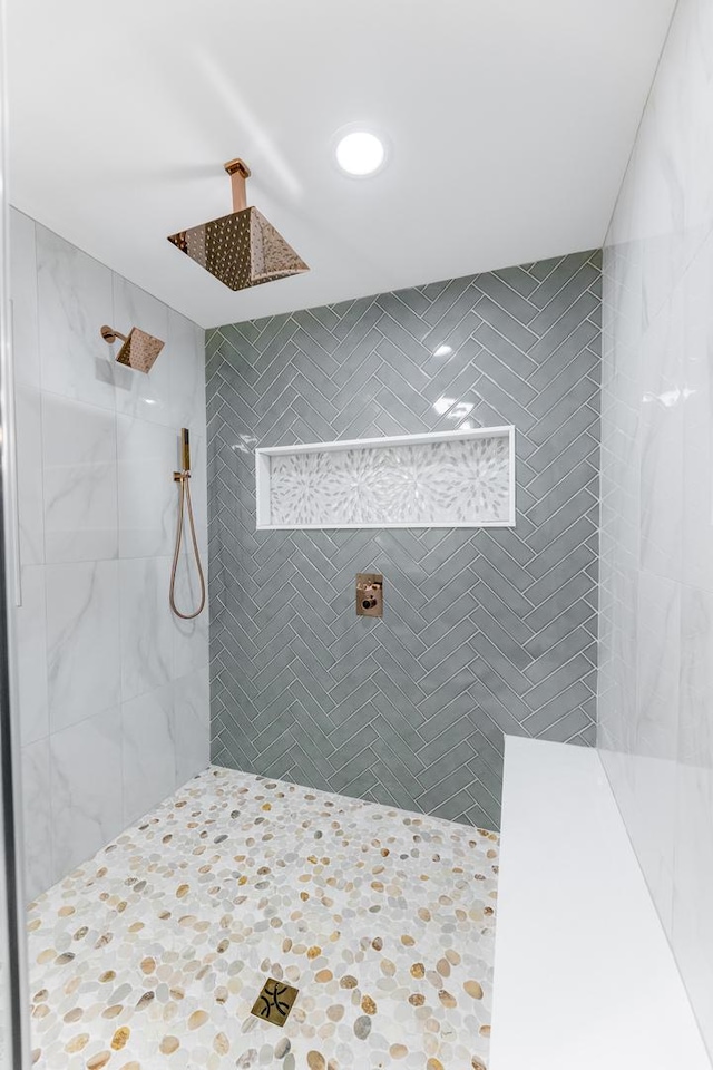 bathroom with a tile shower