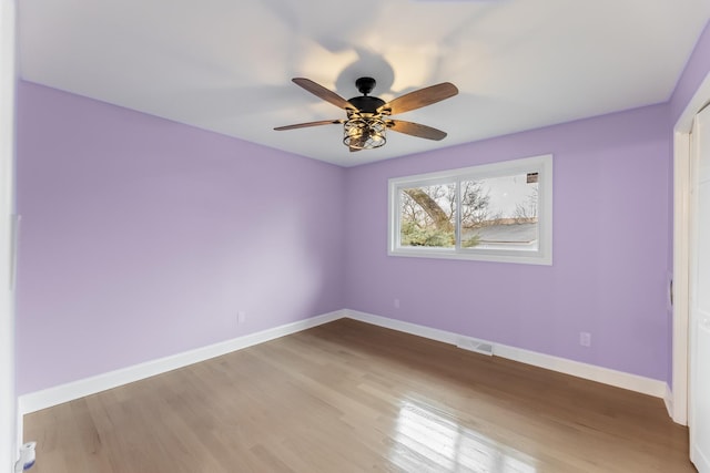 unfurnished room with hardwood / wood-style floors and ceiling fan