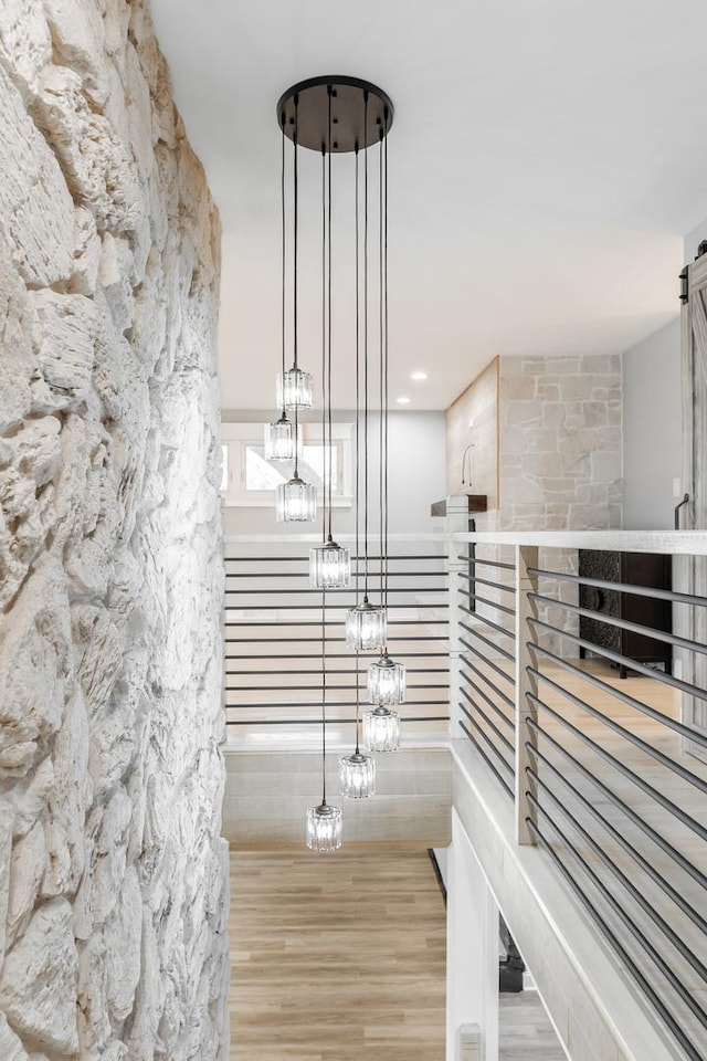 staircase with an inviting chandelier and hardwood / wood-style floors