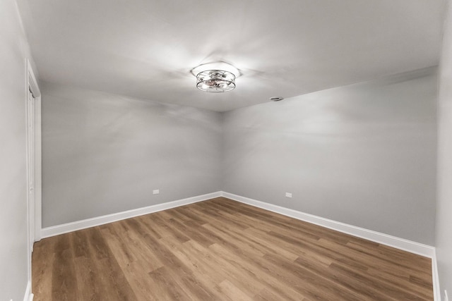 empty room with hardwood / wood-style flooring