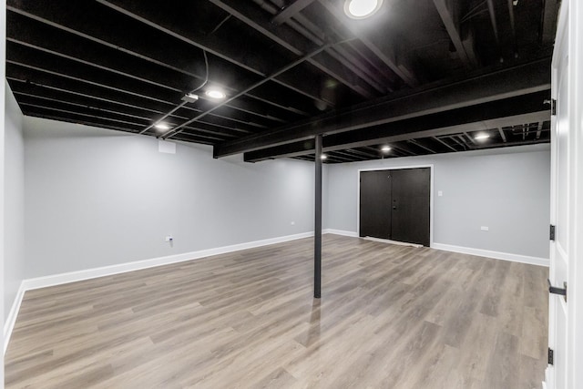 basement featuring hardwood / wood-style floors