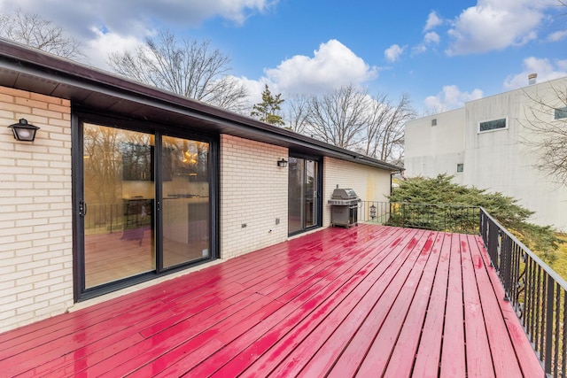 wooden terrace featuring area for grilling