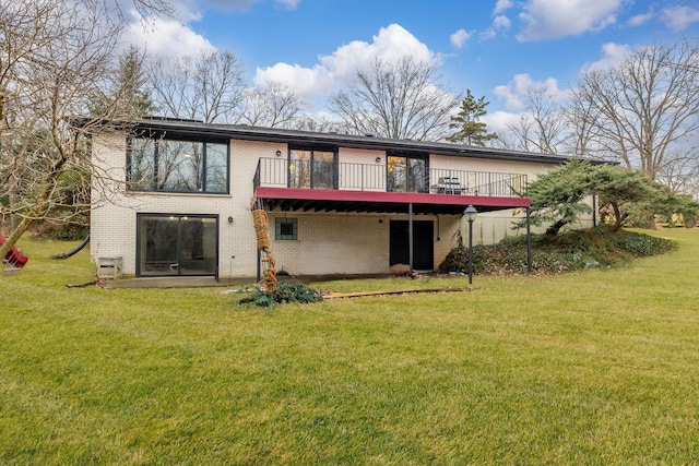 rear view of property with a deck and a lawn